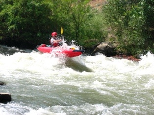 Beth kayaking catching air