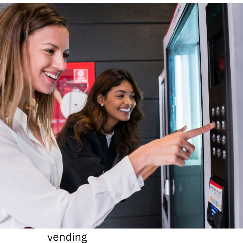 two women using a vending machine